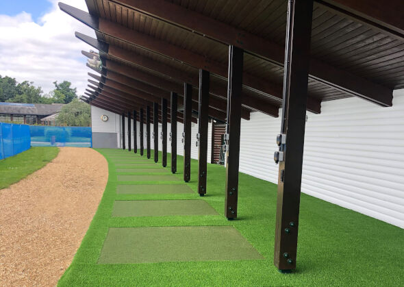 Toronto Covered outdoor tee line with light green synthetic grass boxes inside a dark green synthetic grass strip